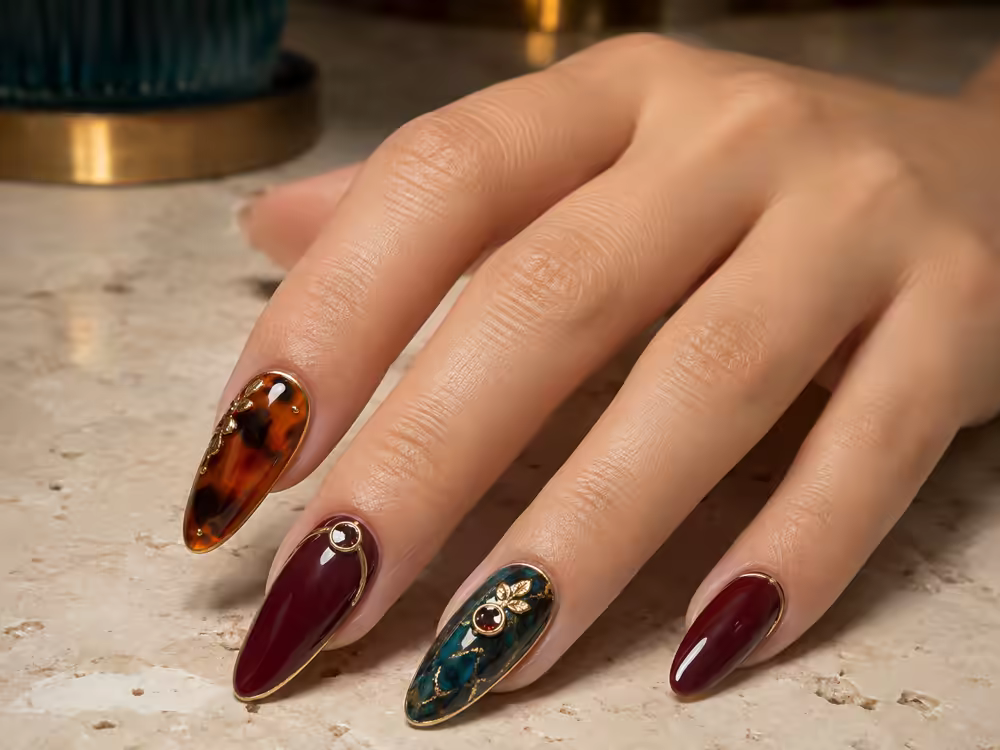 Intricate sculpted acrylic nails with tortoiseshell, oxblood and gold detailing at Element Nail Bar in Avondale